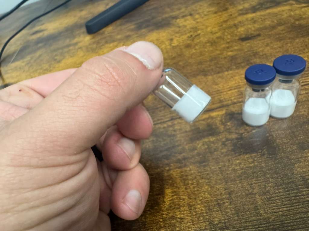 Close-up of a white peptide freeze-dried vial cake from a small-batch lyophilizer
